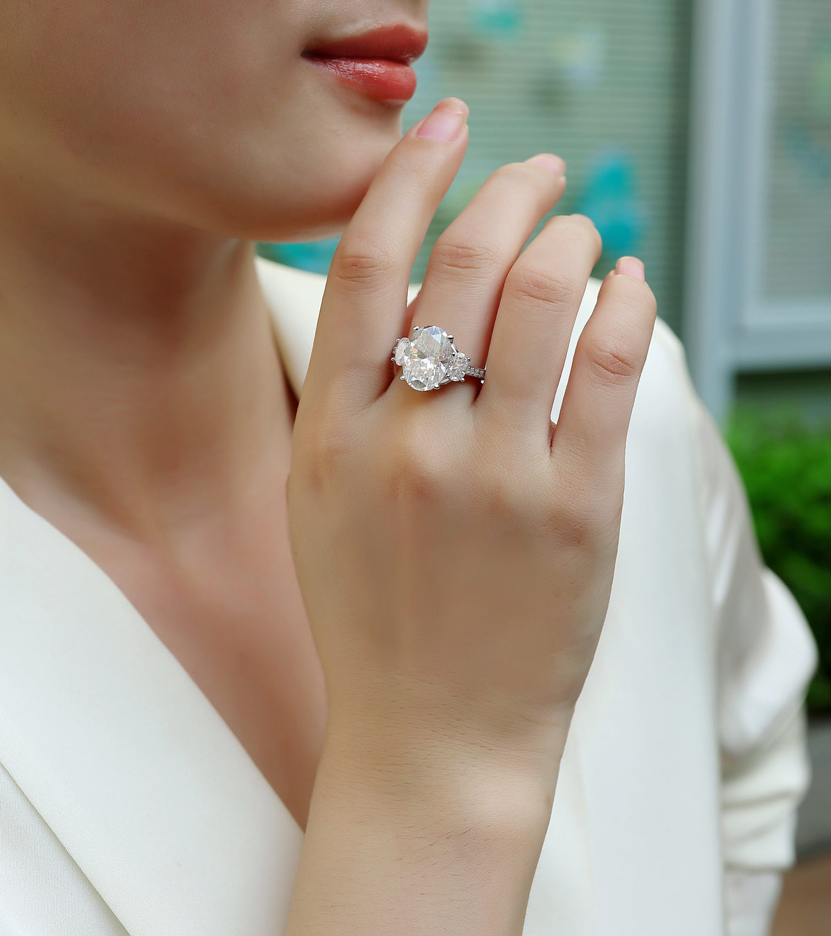 Oval Moissanite Three-Stone Ring with Half-Moon Sides in 925 Silver - worn