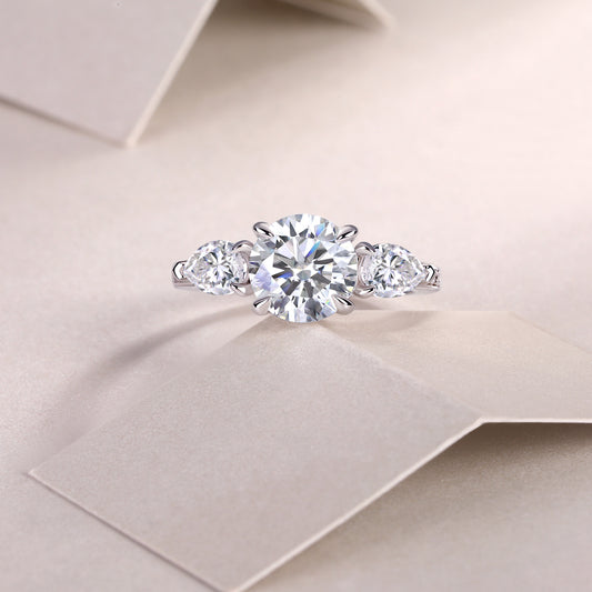 Round Moissanite Ring with Pear Side Stones in 925 Sterling Silver