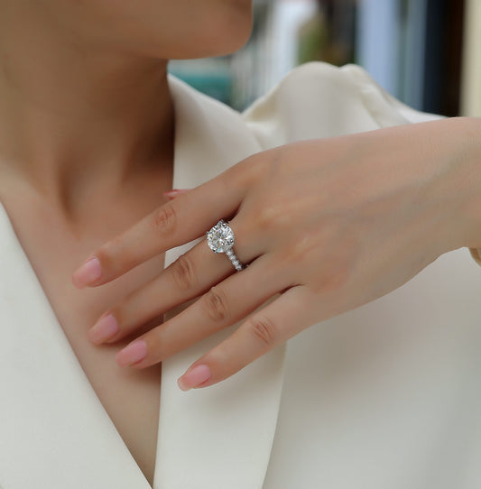 Round Moissanite Four-Prong Solitaire with Pave Band in 925 Silver - worn