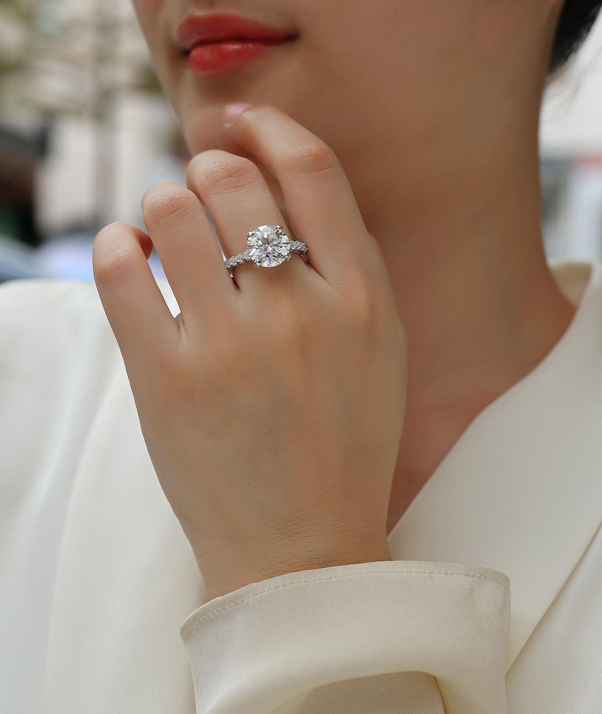Round Moissanite Four-Prong Solitaire with Pave Band in 925 Silver - worn