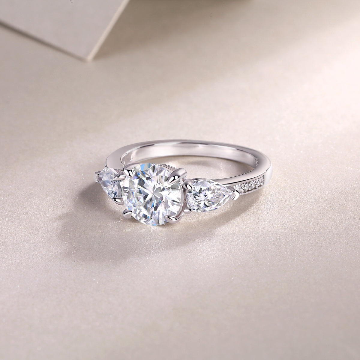 Round Moissanite Ring with Pear Side Stones in 925 Sterling Silver