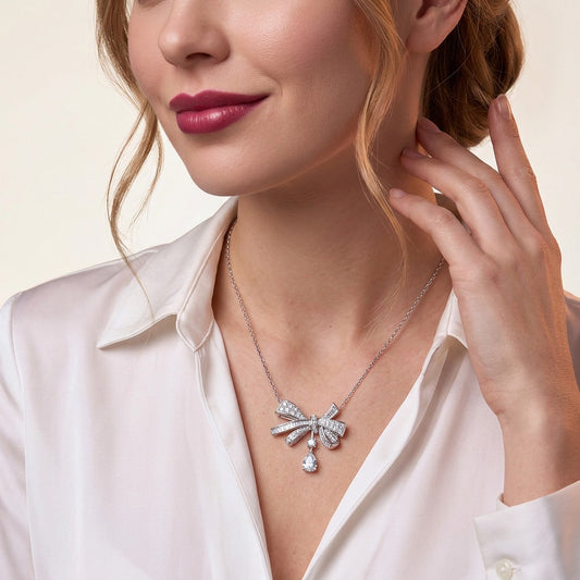 Moissanite Pave Bow Pendant Necklace with Pear Drop in 925 Silver - on model