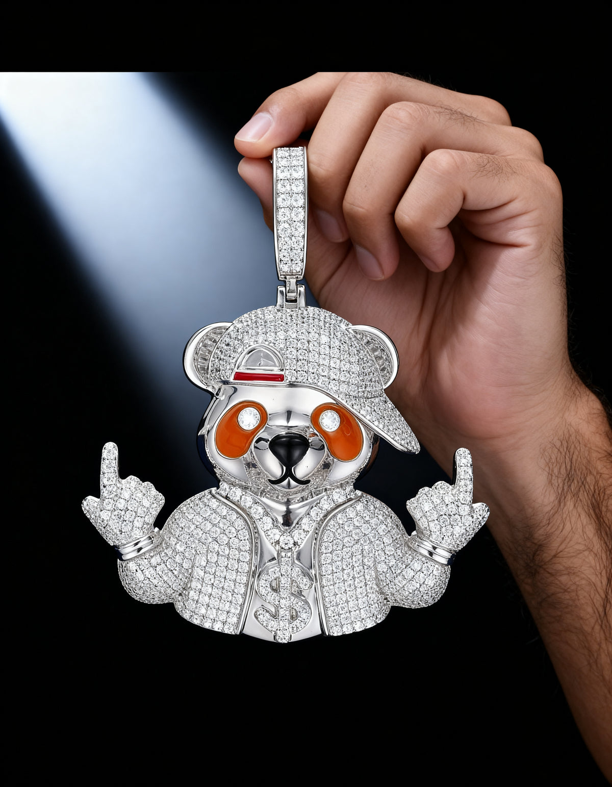 Iced Out Bear Pendant in 925 silver with moissanite - held in hand in a soft beam of light