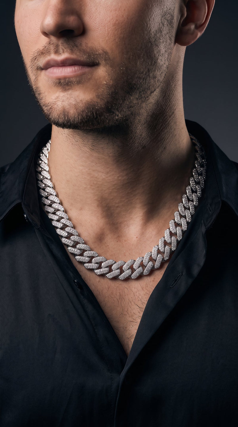 Man in a black silk shirt wearing an iced-out Cuban link chain