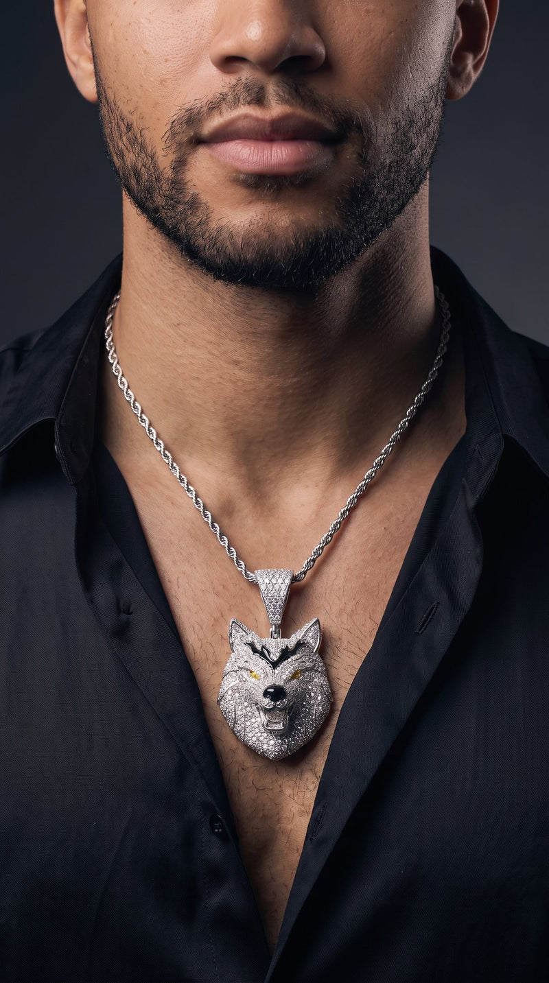 Man in a black silk shirt wearing an iced-out wolf head pendant on a rope chain