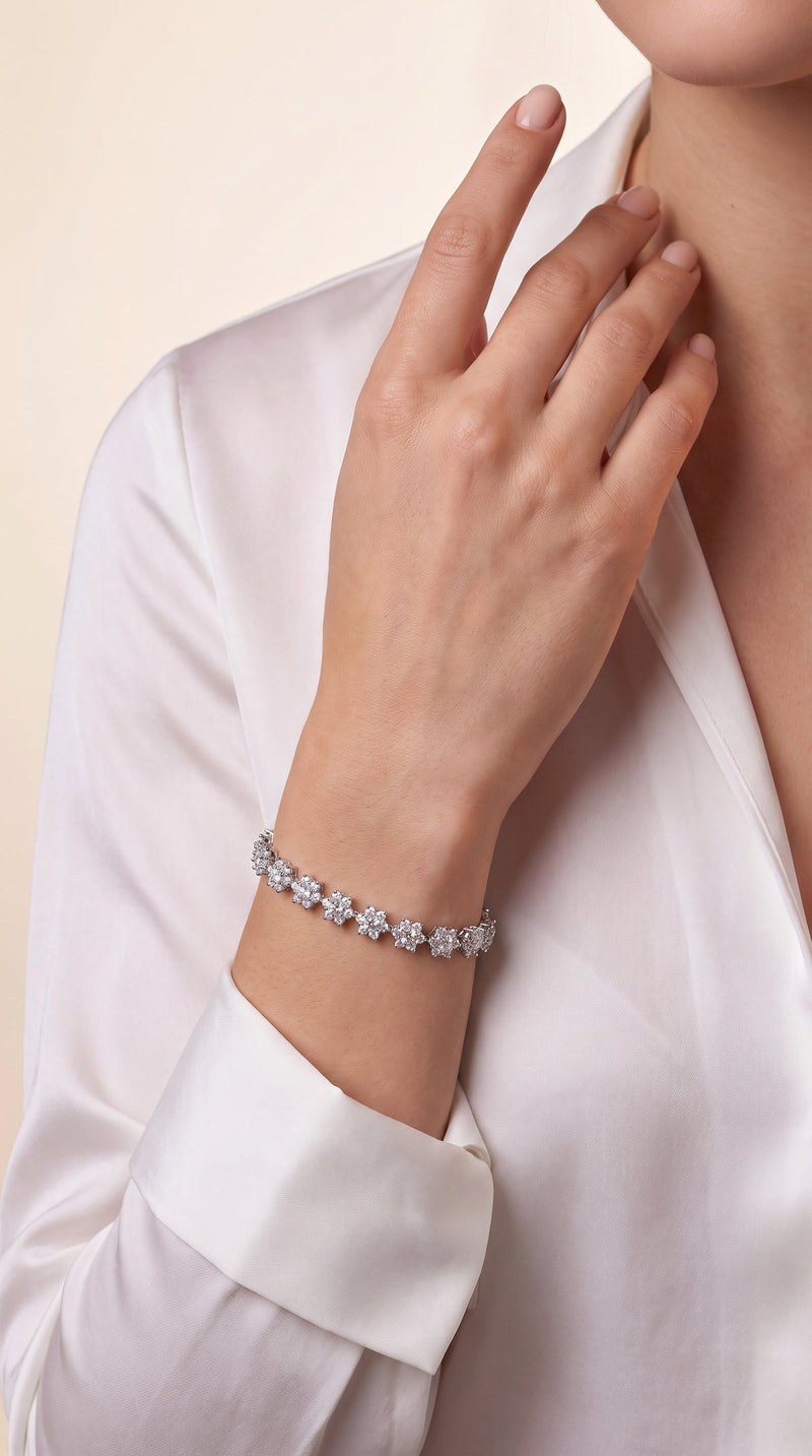 Woman's wrist wearing a flower moissanite tennis bracelet